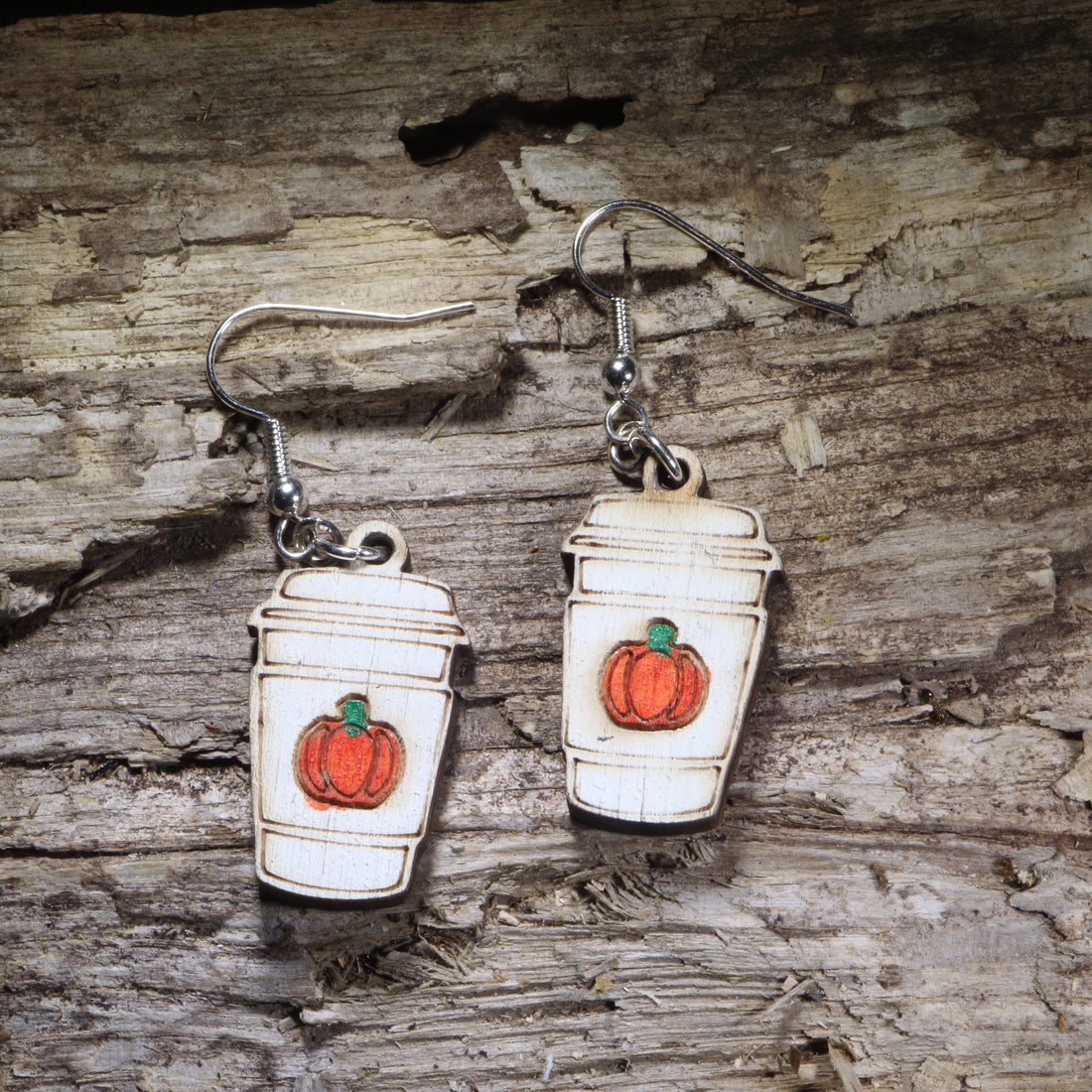 Pumpkin spice latte wooden dangle earrings featuring a hand-painted fall coffee cup with festive pumpkin details. Lightweight autumn earrings with hypoallergenic .925 sterling silver hooks, perfect for coffee lovers, pumpkin spice fans, baristas, fall festivals, cozy seasonal outfits, and autumn jewelry gifts.