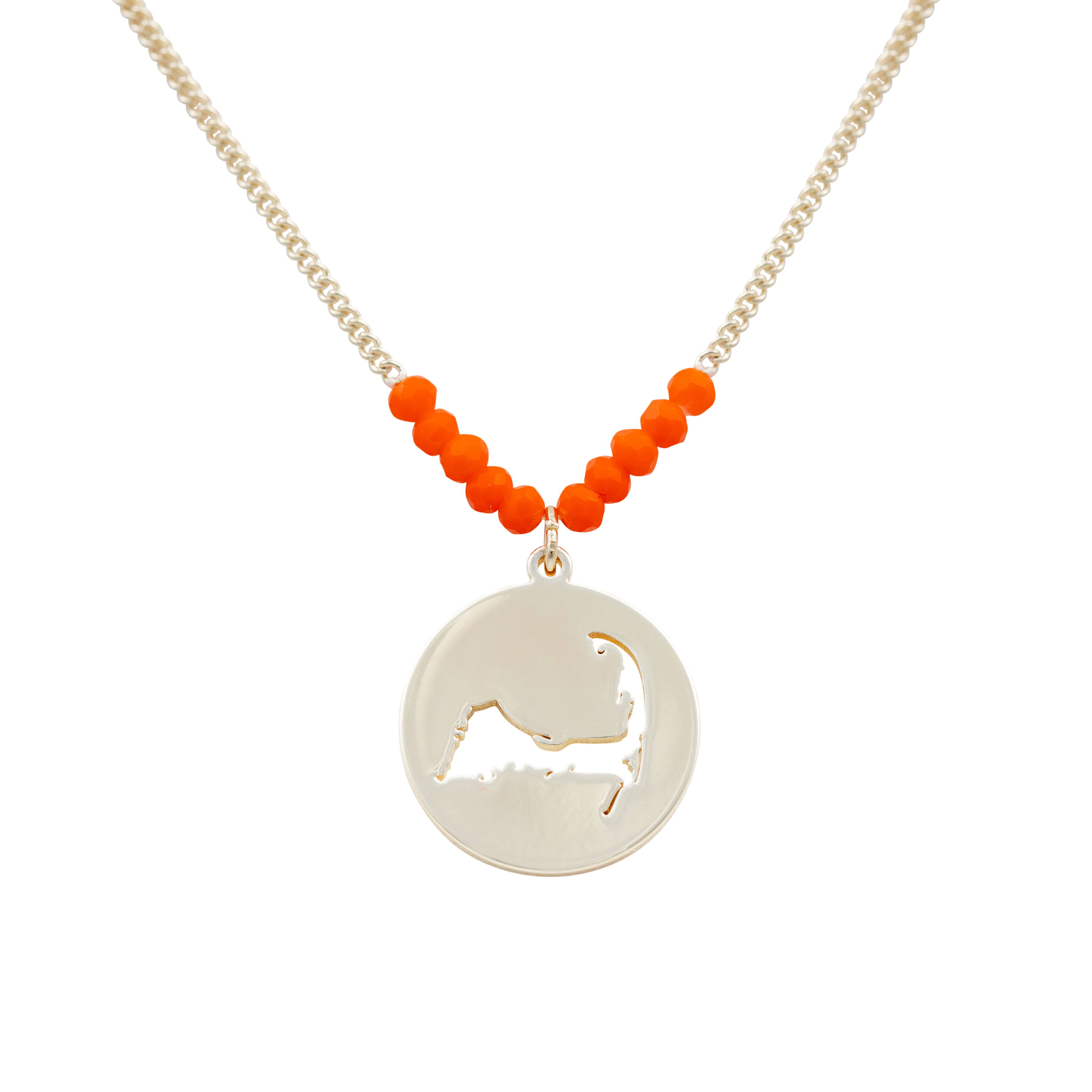 the beach and back cape cod necklace in gold with coral beads at center of chain and coin shape pendant with cutout silhouette of cape cod