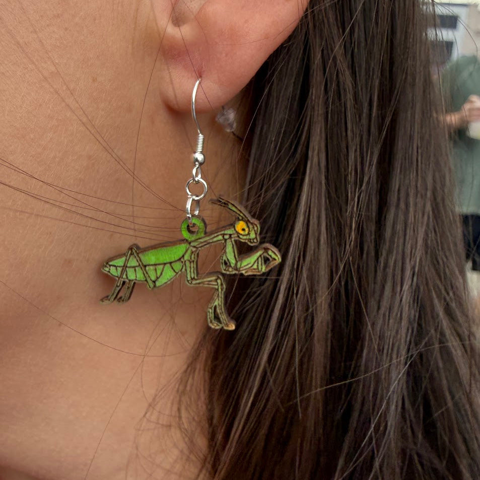 Close-up of hand-painted wooden Realistic Praying Mantis Wooden Dangle Earrings | Female Entomology Jewelrywith hypoallergenic silver hooks, insect nature jewelry by Cate’s Concepts