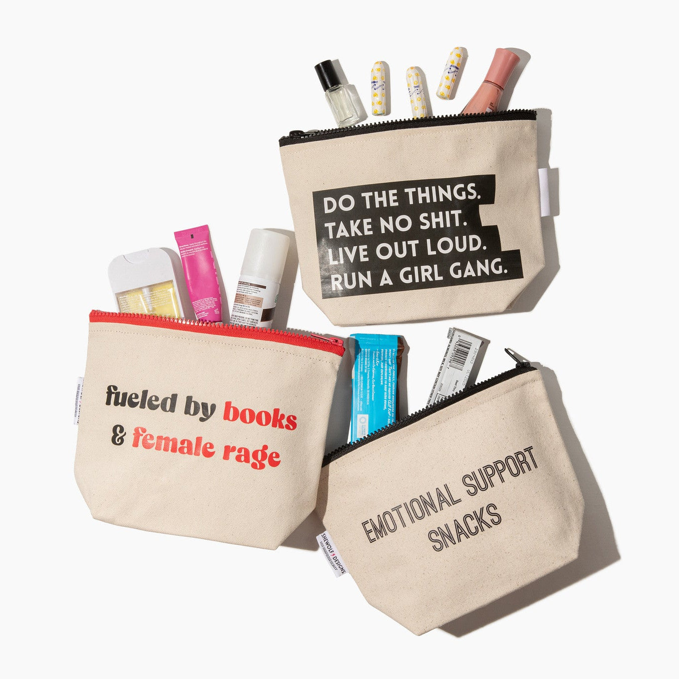 Three canvas pouches with motivational text and stationery items on a white background