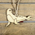 Hand-painted wooden sea lion Christmas ornament featuring a playful coastal animal design with smooth curved body and flippers, unique holiday decor for ocean lovers and marine life enthusiasts by Cate’s Concepts