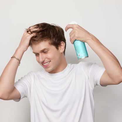 Man styling his hair with Sea Salt Spray to give texture and definition to hair in eco friendly aluminum plastic free bottle.
