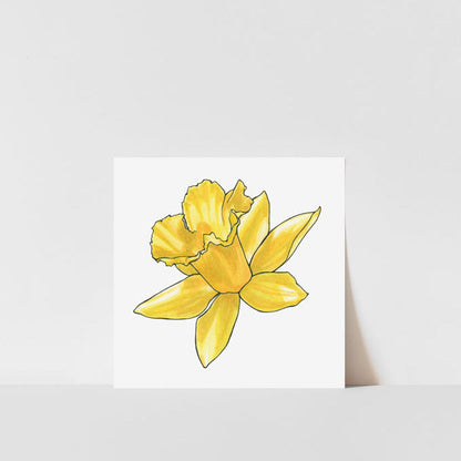 A printed art piece of a single daffodil flower with a yellow petals, displayed against a white background.