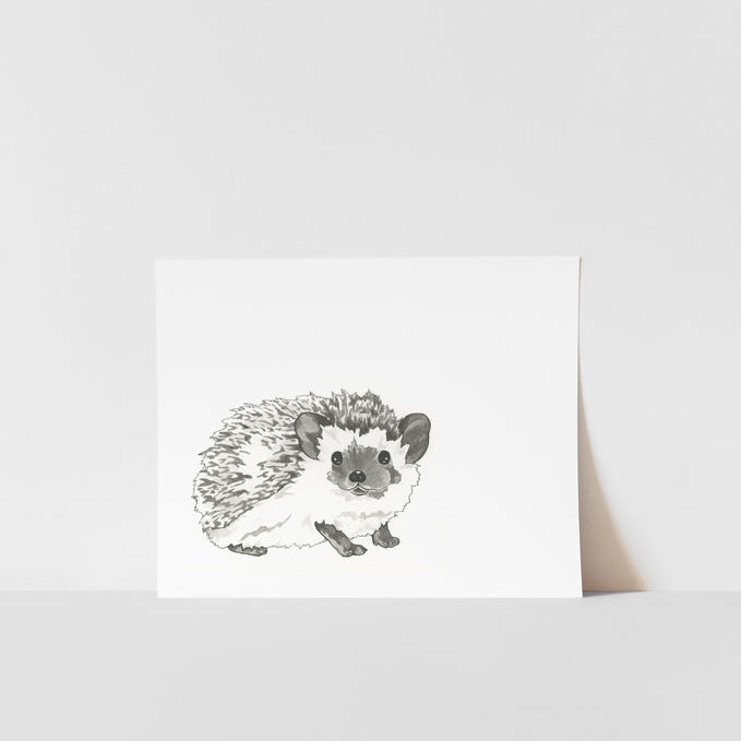 A black and white ink print of a hedgehog positioned in the center on a white background.