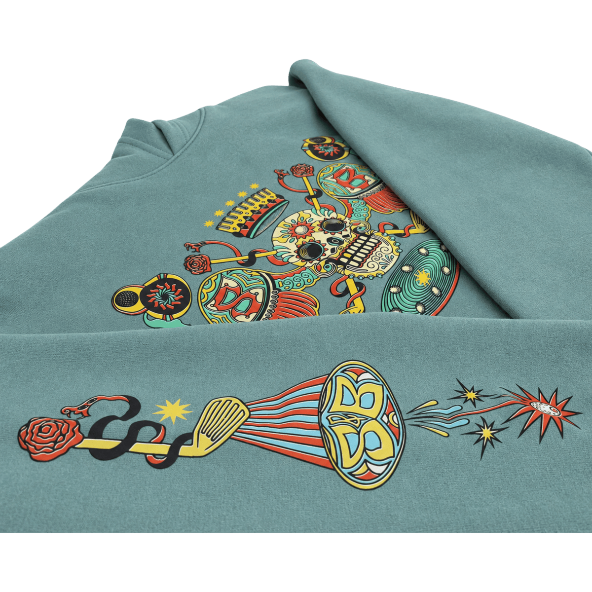 An Arctic Blue Skull &amp; Bogeys hoodie featuring a large, colorful graphic print on the front. The design is highly detailed and multicolored, containing elements like a skull, a horn, a snake, a rose, and stars, set against a clean white background.