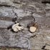 Handcrafted wooden mismatched squirrel and acorn dangle earrings featuring a playful woodland design with natural wood tones and engraved details. These lightweight earrings are finished with hypoallergenic .925 sterling silver hooks, making them a charming accessory for nature lovers, autumn outfits, and woodland-inspired style.