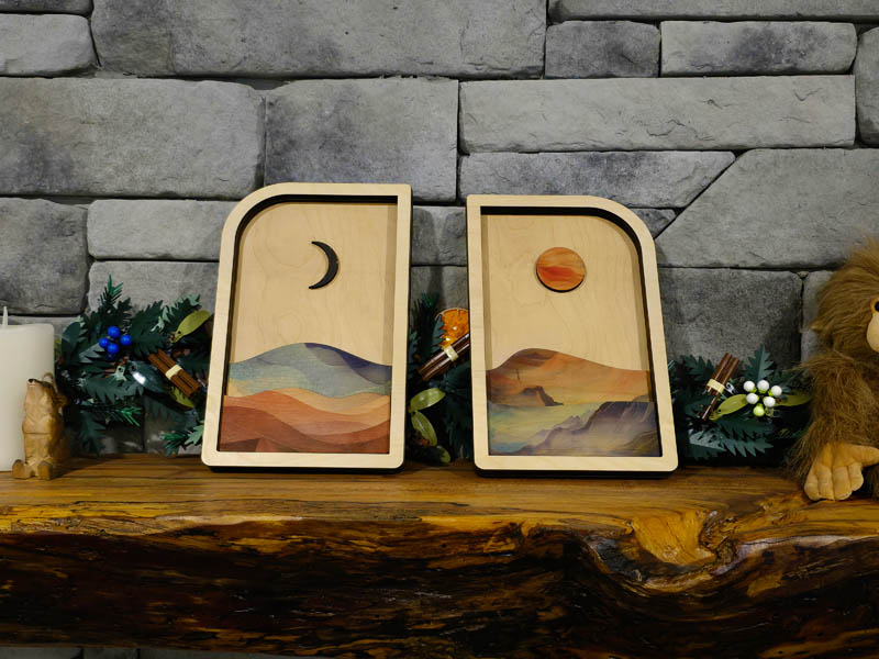 Sun and moon wood wall art set displayed on a stone mantle, layered Baltic birch panels handmade in Ohio