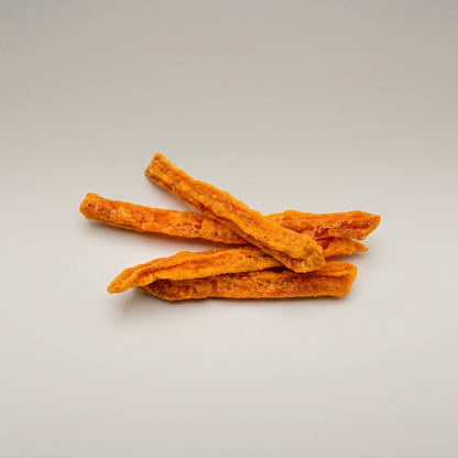 Orange dog treats on a light gray background