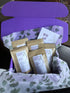 Five teas and a $10 off coupon in a bright purple gift box
