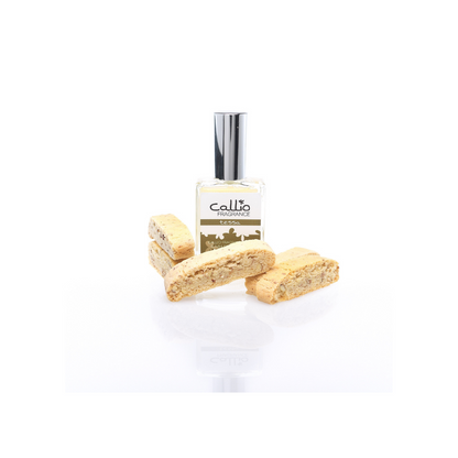 One ounce Tessa Spray Perfume surrounded by 5 almond biscotti cookies on a white background.