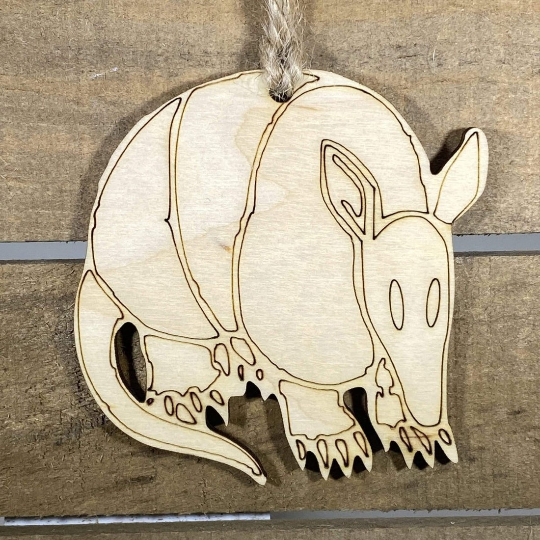 Hand-painted wooden Texas armadillo Christmas ornament featuring a quirky armored armadillo design with playful Southwestern style, funny holiday decor for Texas lovers and wildlife fans by Cate’s Concepts