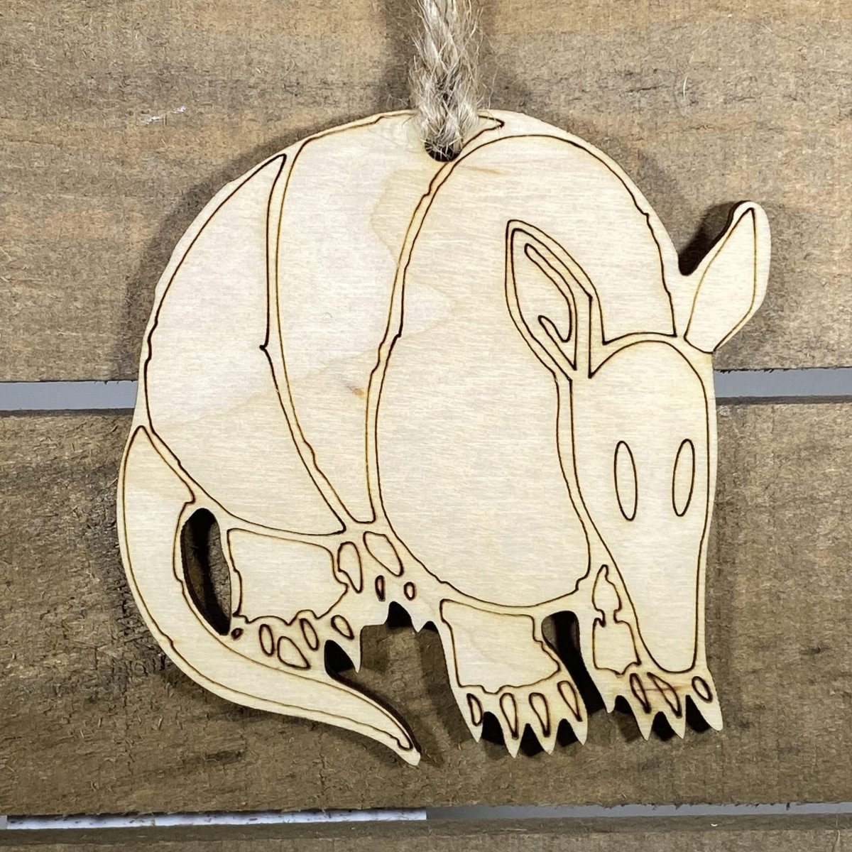 Hand-painted wooden Texas armadillo Christmas ornament featuring a quirky armored armadillo design with playful Southwestern style, funny holiday decor for Texas lovers and wildlife fans by Cate’s Concepts