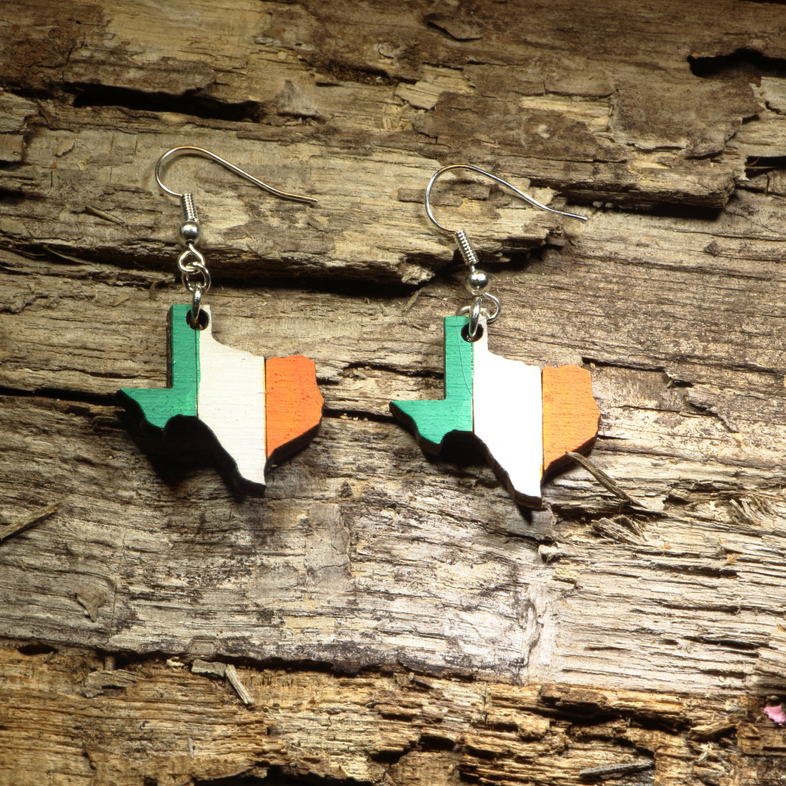 Hand-painted wooden Texas state dangle earrings featuring the outline of Texas painted in the green, white, and orange colors of the Irish flag. Crafted from lightweight wood with hypoallergenic .925 sterling silver hooks, these unique earrings are perfect for Irish Texans, St. Patrick&