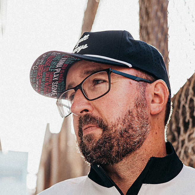 Skull &amp; Bogeys black golf snapback hat with white script embroidery and white rope