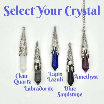 A product selection graphic showing four crystal pendant necklaces with silver filigree settings and labeled stones: Clear Quartz, Lapis Lazuli, Blue Sandstone, and Amethyst. The image includes the text &