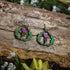 Hand-painted wooden thistle dangle earrings featuring a purple Scottish thistle framed by Celtic-inspired greenery, hypoallergenic sterling silver hooks, and lightweight heritage jewelry for Scottish pride, Celtic culture, and nature lovers by Cate’s Concepts