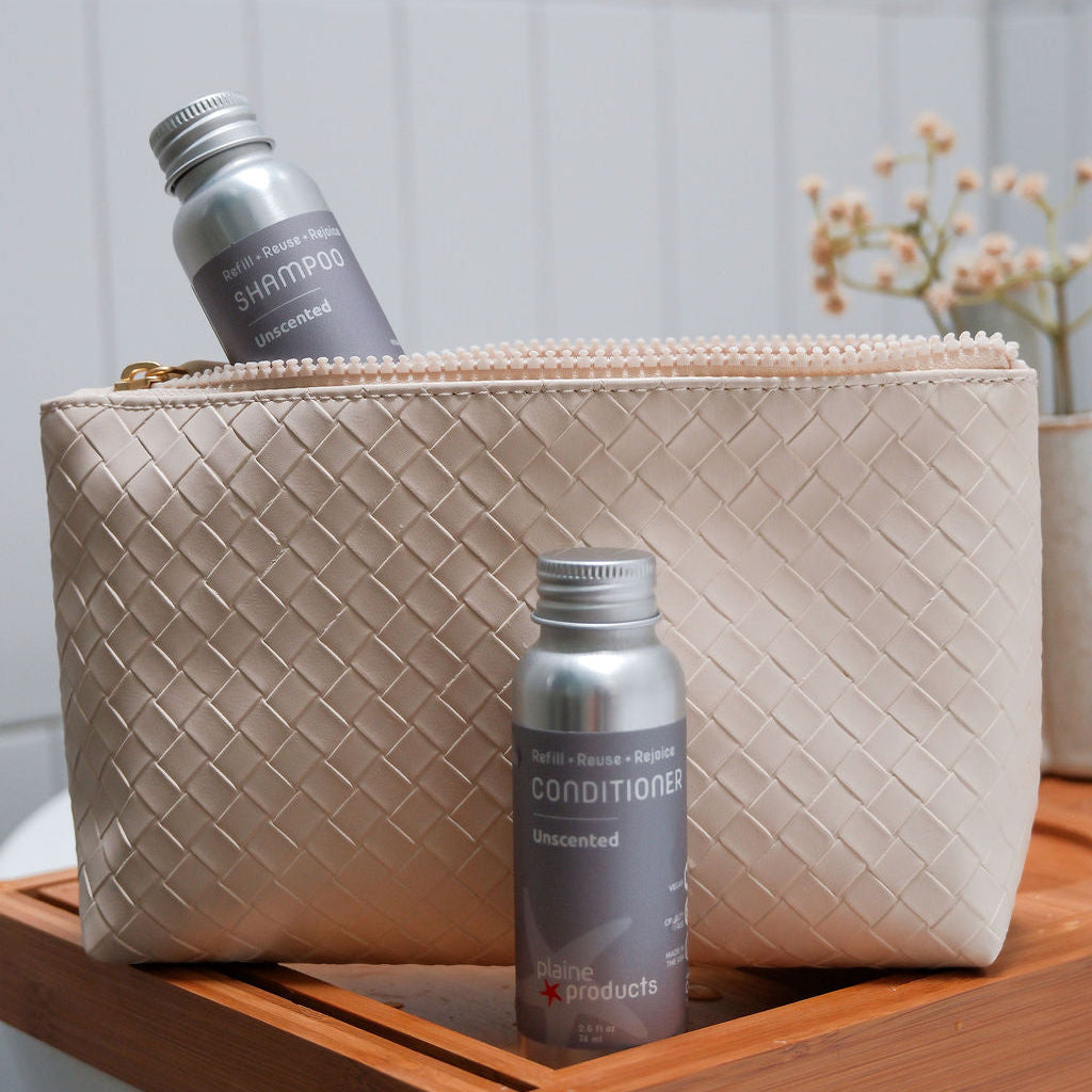 Travel TSA approved unscented, fragrance free shampoo and conditioner in aluminum bottles in a vacation pouch. 