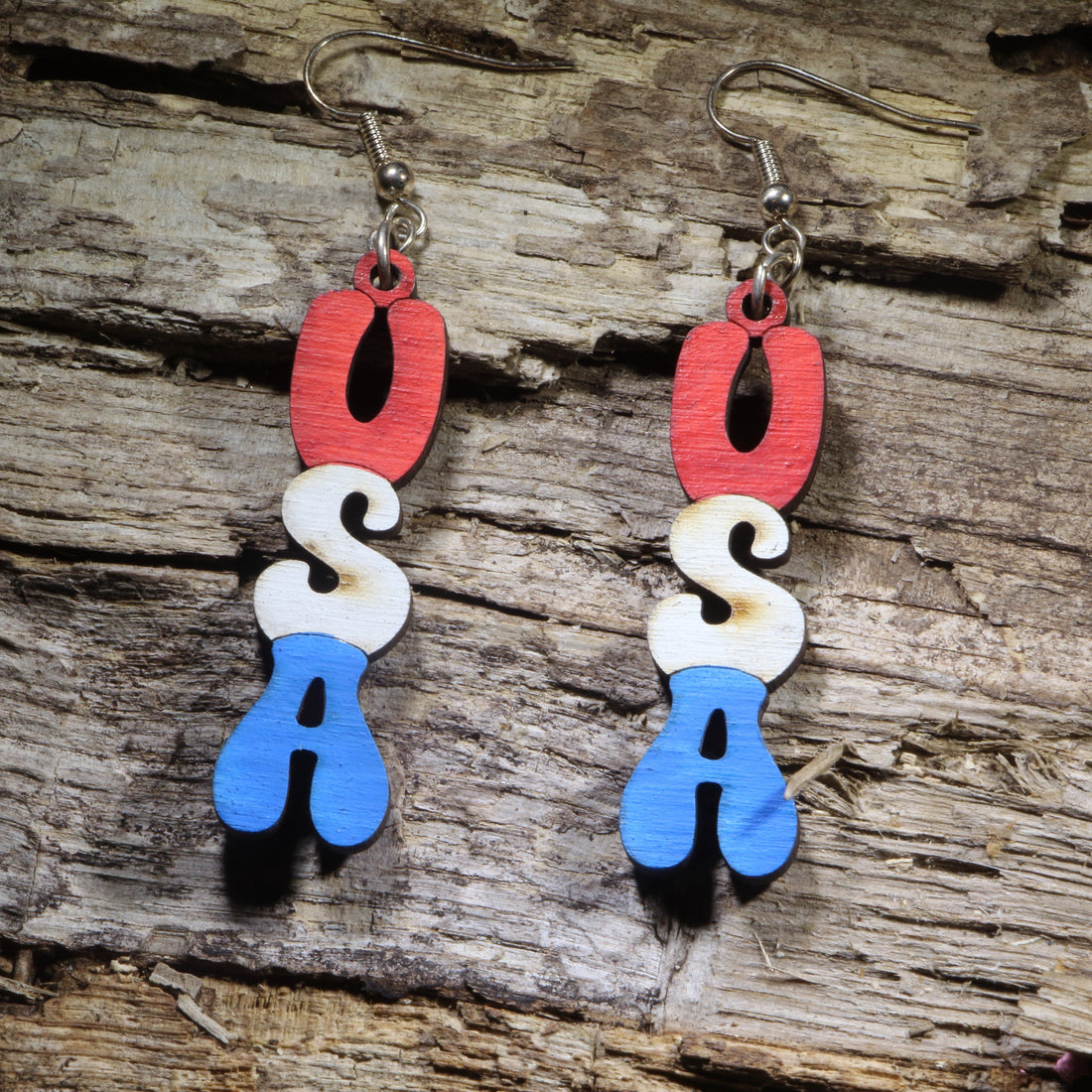 Hand-painted USA-shaped wooden dangle earrings on hypoallergenic .925 sterling silver hooks. Lightweight patriotic American jewelry perfect for Independence Day, Memorial Day, Veterans Day, military families, and proud Americans.
