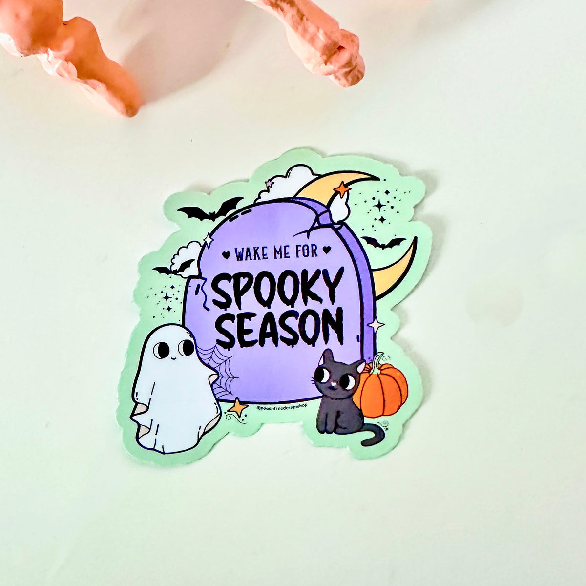 A die-cut sticker featuring a purple tombstone with the text &