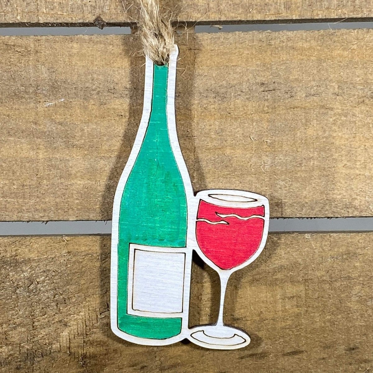 Hand-painted wooden wine bottle and glass Christmas ornament featuring a festive wine pairing design with detailed bottle and filled glass, unique holiday decor for wine lovers and entertaining enthusiasts by Cate’s Concepts