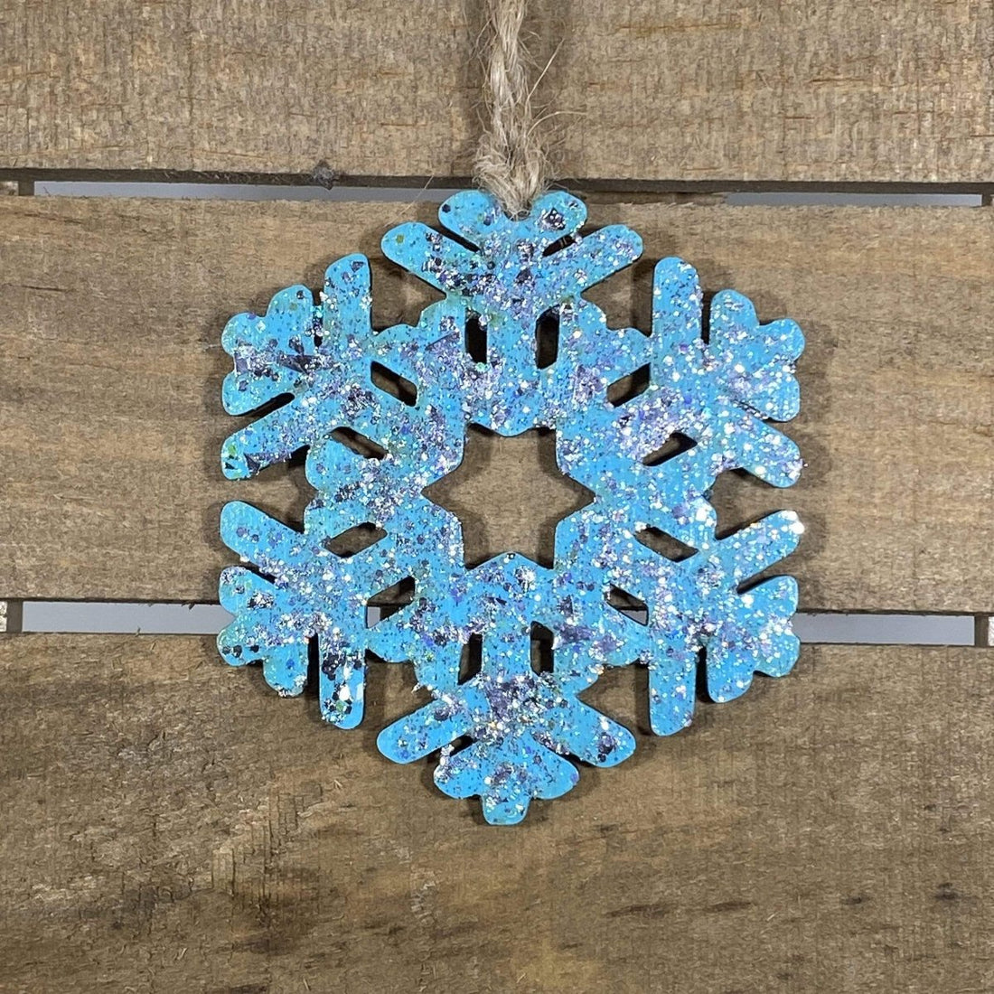 Hand-painted wooden winter snowflake Christmas ornament featuring an intricate symmetrical snowflake design with delicate cutout details, elegant holiday decor for winter lovers and festive seasonal displays by Cate’s Concepts