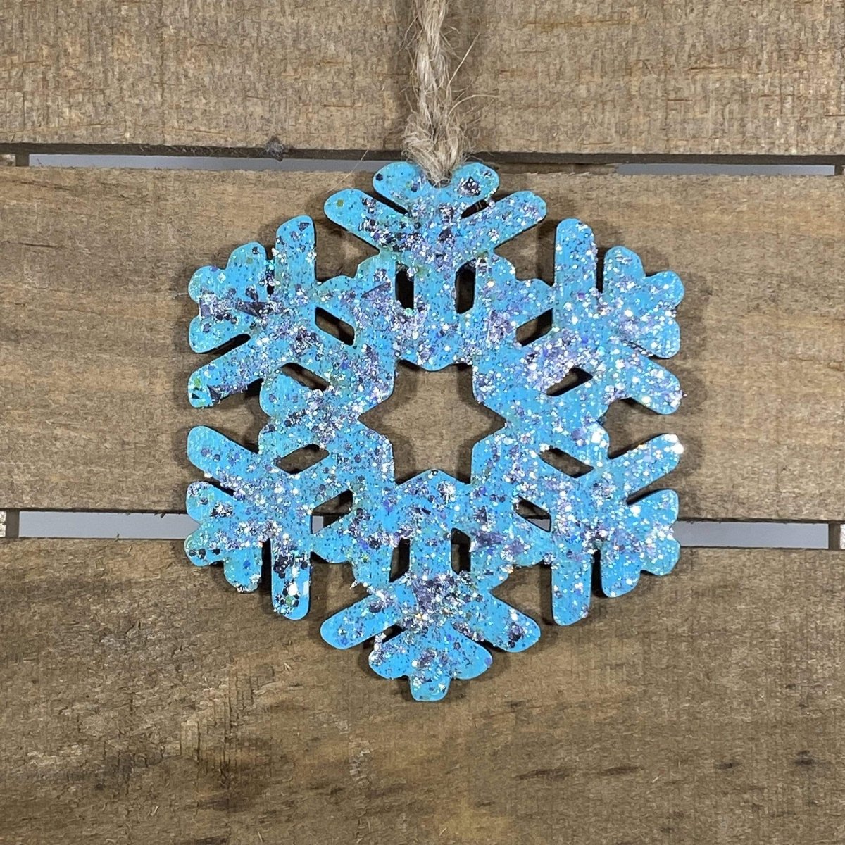 Hand-painted wooden winter snowflake Christmas ornament featuring an intricate symmetrical snowflake design with delicate cutout details, elegant holiday decor for winter lovers and festive seasonal displays by Cate’s Concepts