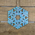 Hand-painted wooden winter snowflake Christmas ornament featuring an intricate symmetrical snowflake design with delicate cutout details, elegant holiday decor for winter lovers and festive seasonal displays by Cate’s Concepts