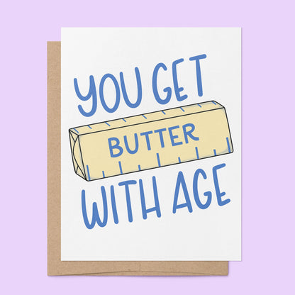 You Get Butter With Age Birthday Card flat lay — funny food pun card for bakers by indie artist MangoIllustrated