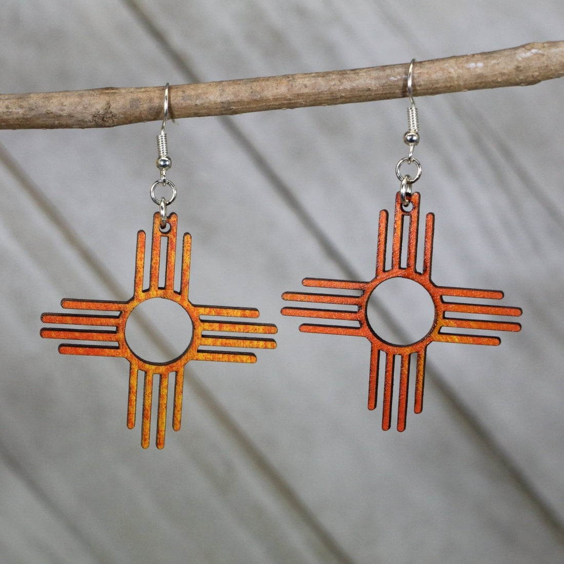 Hand-painted wooden Zia sun symbol dangle earrings with New Mexico state design and hypoallergenic sterling silver hooks, lightweight Zia statement jewelry earrings for southwestern style and NM pride