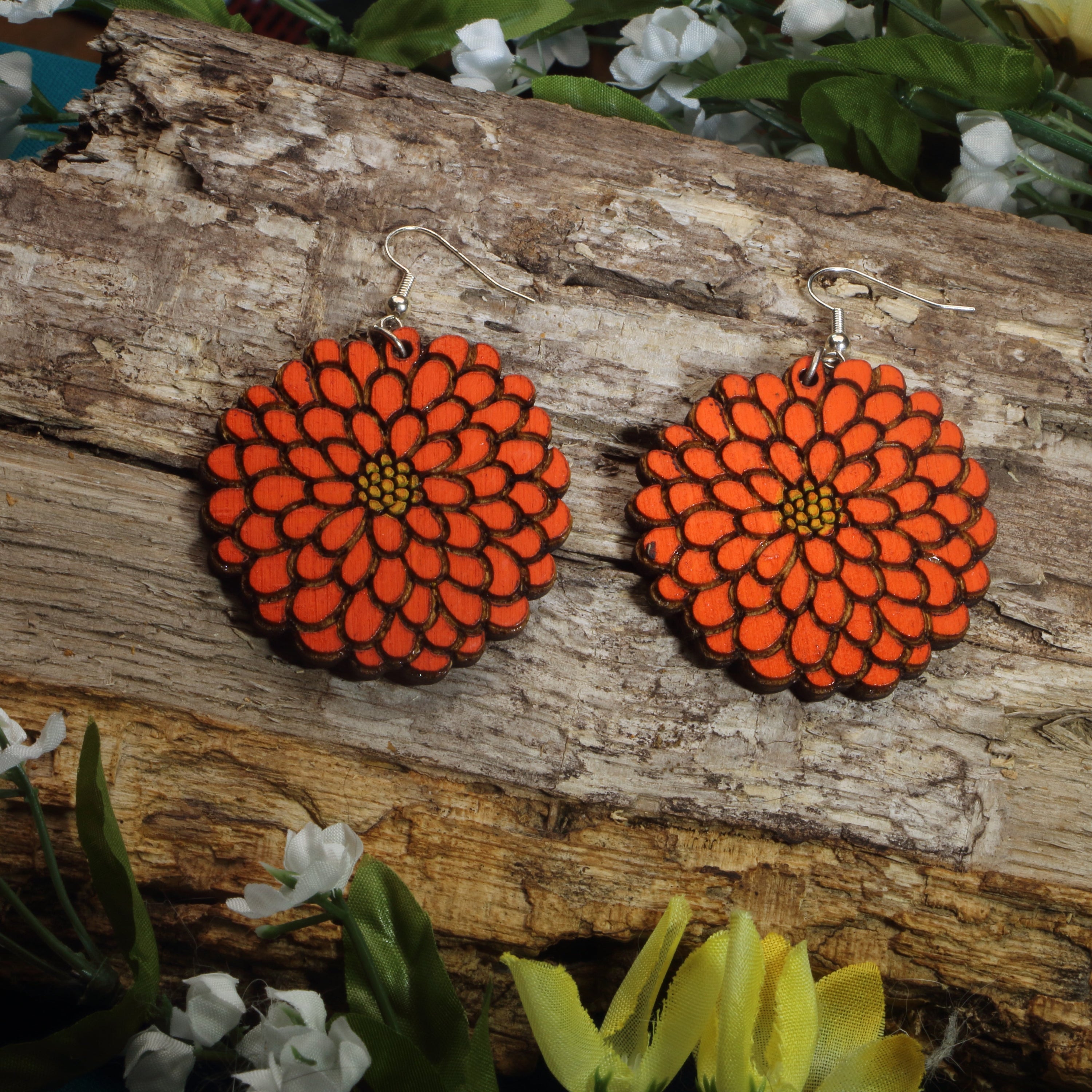 Hand-painted wooden zinnia flower dangle earrings featuring vibrant orange floral artwork, hypoallergenic sterling silver hooks, and lightweight botanical jewelry for gardeners, flower lovers, and nature-inspired style by Cate’s Concepts.