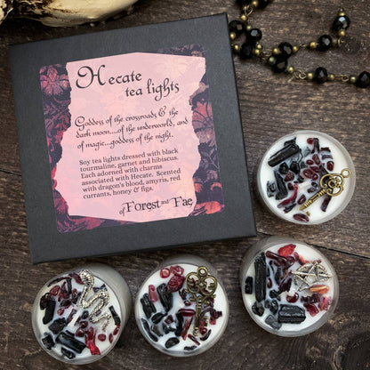 Hecate tea lights packaging with decorative tea lights on a wooden surface