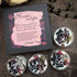 Hecate tea lights packaging with decorative tea lights on a wooden surface