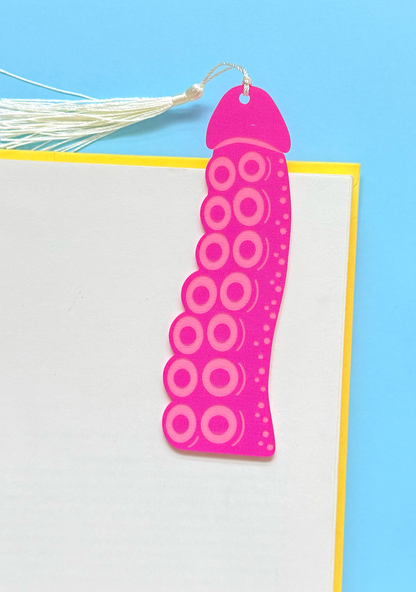 Pink circular patterned bookmark on a blue and white background
