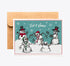 A square greeting card with a kraft envelope behind it, featuring a winter scene with five cartoon snowmen and the words &
