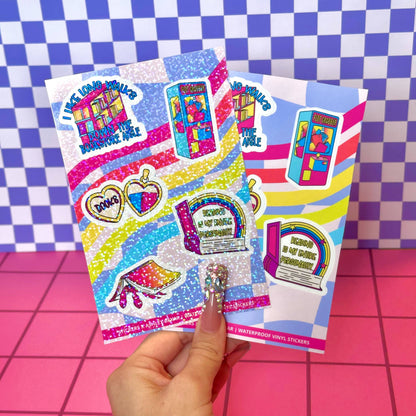 Colorful sticker sheet held by a hand on a checkered background