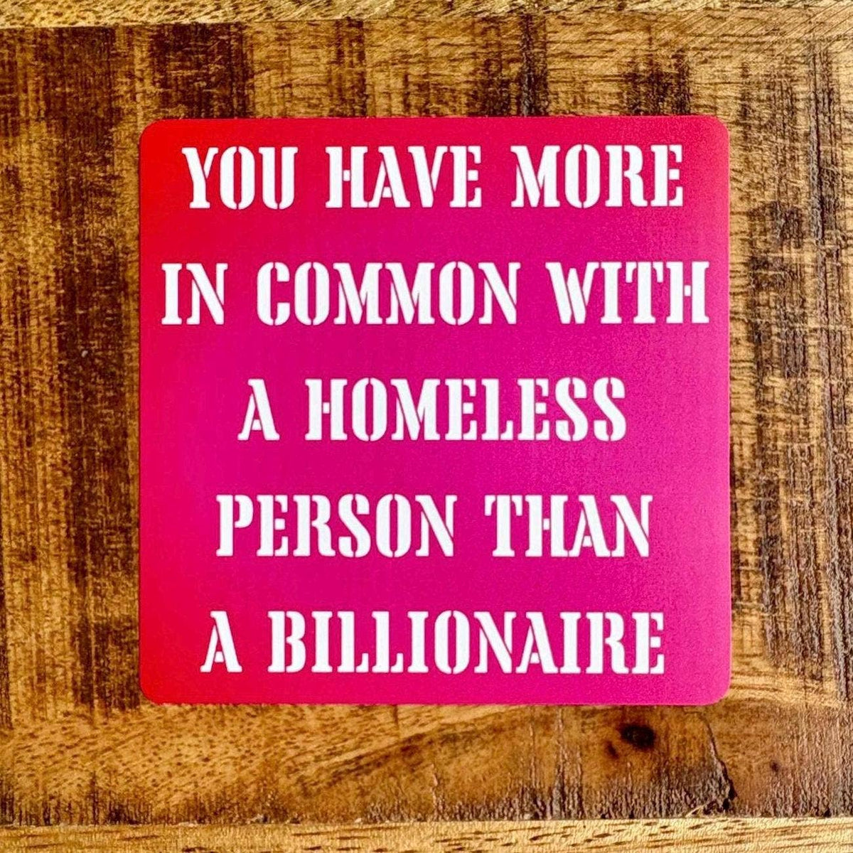 A square pink sign with bold white text reading &