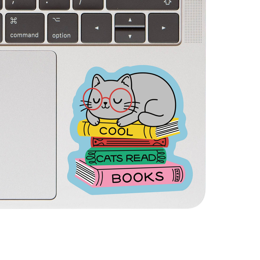 Laptop with a sticker of a cat reading books on the keyboard area
