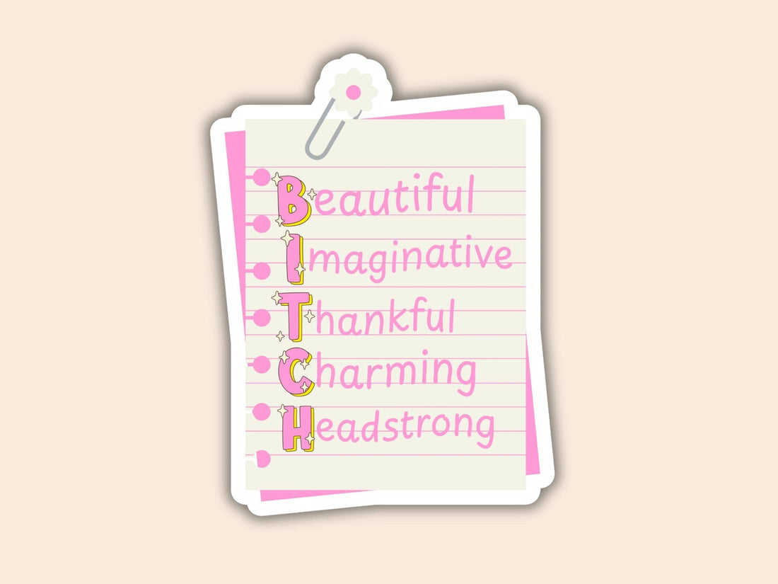 A die-cut sticker designed to look like a lined notepad page clipped at the top, featuring the word &