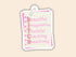 A die-cut sticker designed to look like a lined notepad page clipped at the top, featuring the word &