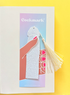 Cockmark product on a colorful card with tassel on a yellow background