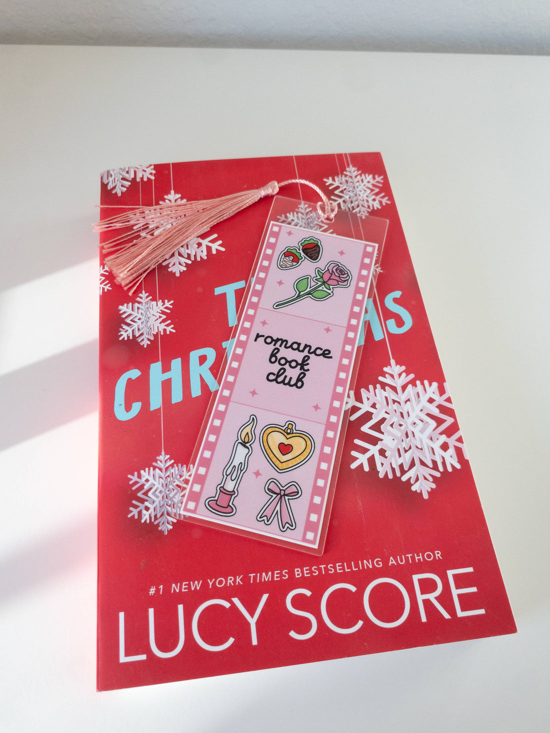 Red book with snowflakes and a bookmark on a white surface