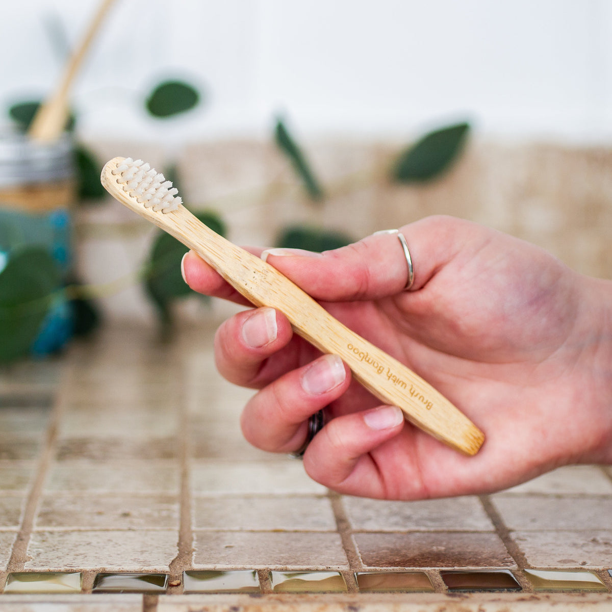 Brush with Bamboo Bamboo Toothbrush - Child Size in Hand