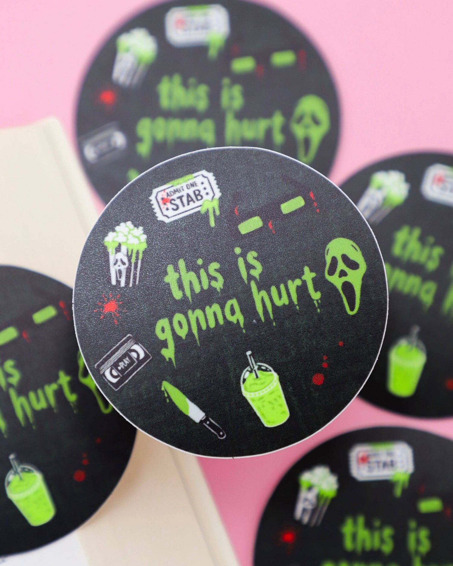 Circular stickers with text and graphics on a pink background