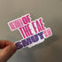 A hand holding a die-cut sticker that reads &
