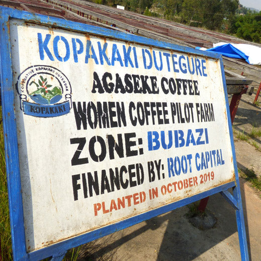 Signboard with text about Agaseke Coffee Women Coffee Pilot Farm in Kopakaki Dutegure, financed by Root Capital.