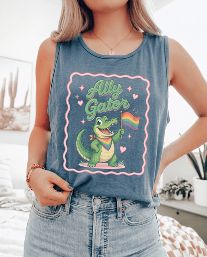 Person wearing a tank top with a cartoon gator holding a rainbow flag and &
