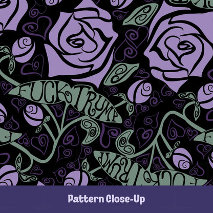 Close-up of Fuck trump mug pattern showing blue roses and sage-green hand-lettered banners on black ceramic