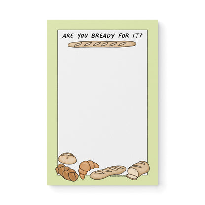 Notepad with green border, bread illustrations (baguette, croissant, loaf), and text “Are You Bready For It?” – cute Swiftie bread-themed stationery gift.
