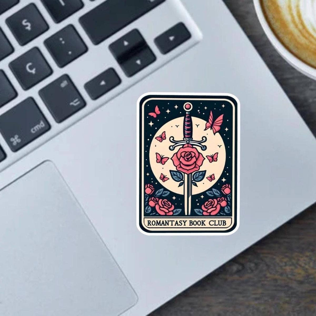 Sticker with a sword and roses design on a laptop