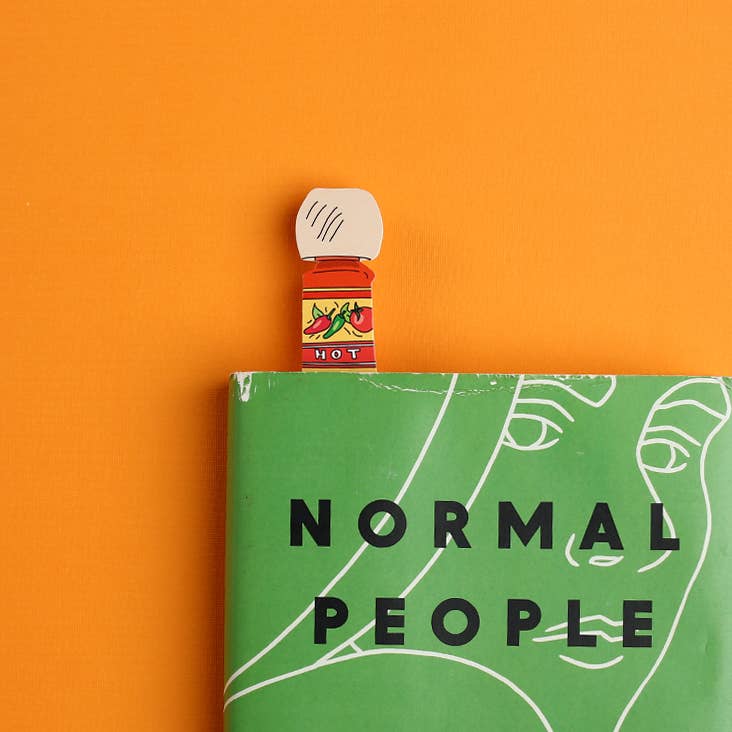 Small bottle of hot sauce on a book titled &